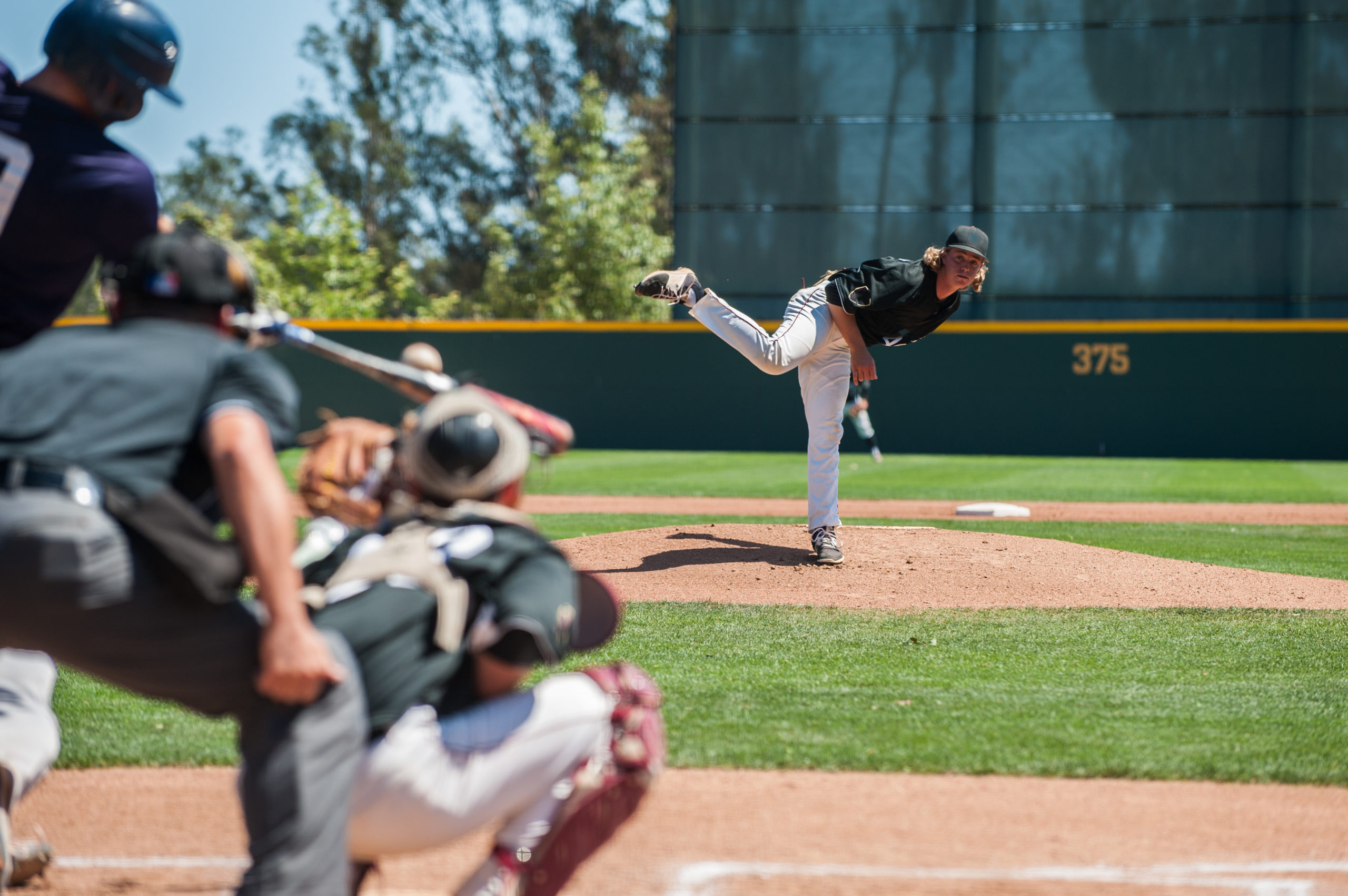 Baseball pitcher following through to pitch to right handed batter.